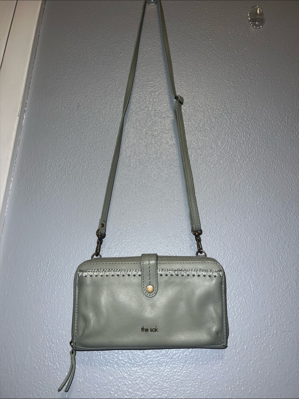 The Sak sage green crossbody wallet